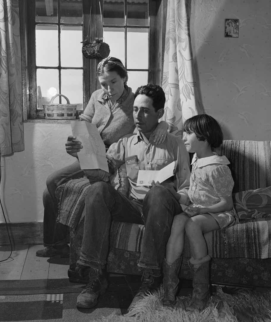 Blas Chavez with his wife and child, reading a letter announcing that he has won  the second prize in the state stock show for the best ram;  Los Cordovas, Taos County, New Mexico, 1943, Library of Congress