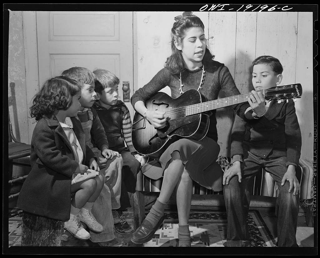 Spanish American girl singing folk songs to her little brothers and sisters, Albuquerque, New Mexico, 1943, Library of Congress